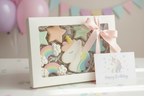Unicorn birthday sugar cookies in a windowed gift box with pink ribbon and a unicorn birthday card